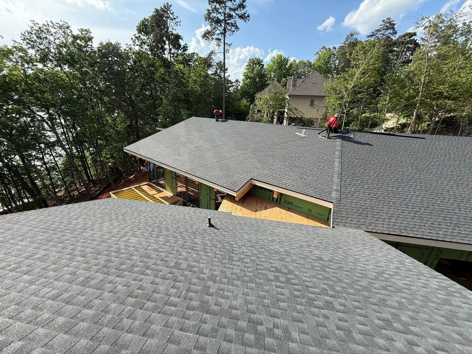 CPR crew installing architectural shingles on a lakeside home